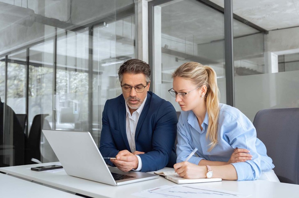 Business Glasfaser: Mitarbeitende arbeiten am Laptop